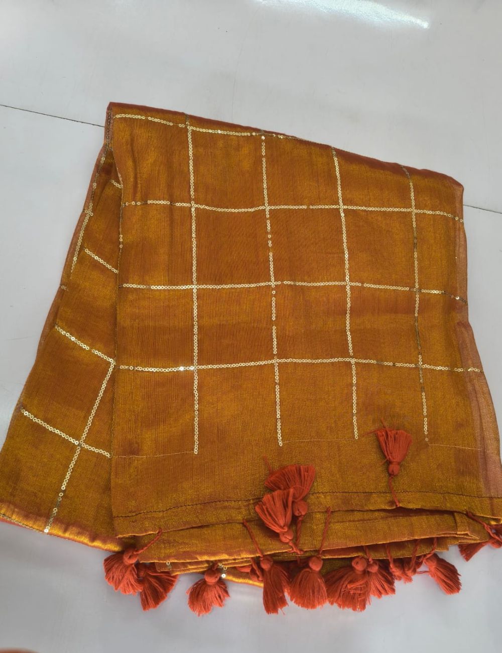 Mulmul Sequence Orange tissue Saree With beautiful tussels